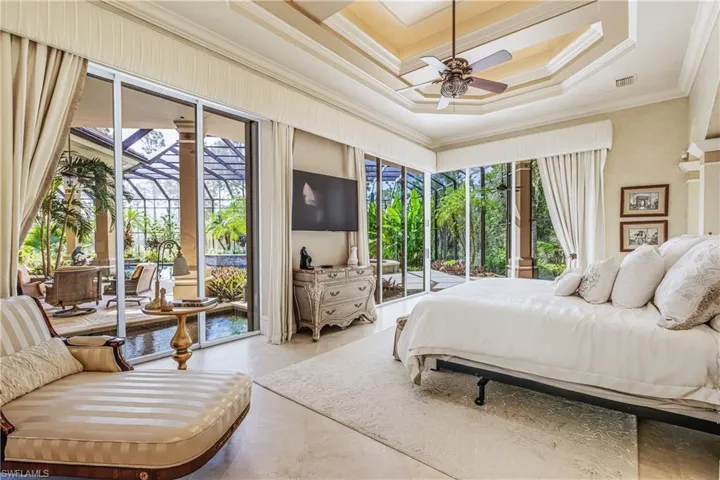 Bedroom with access to outside, ornamental molding, coffered ceiling, a raised ceiling, and a sunroom
