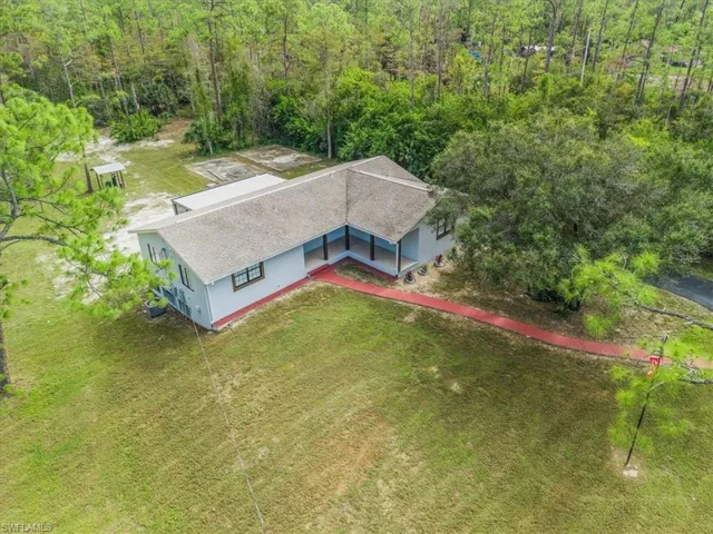 View of subject property featuring a forest