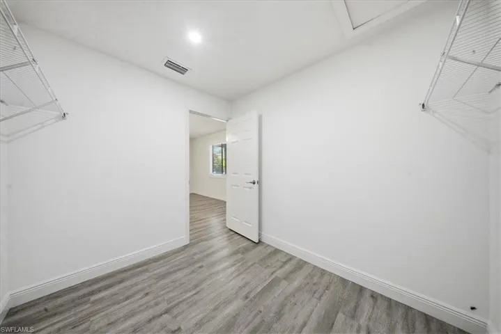 Walk in closet featuring wood finished floors