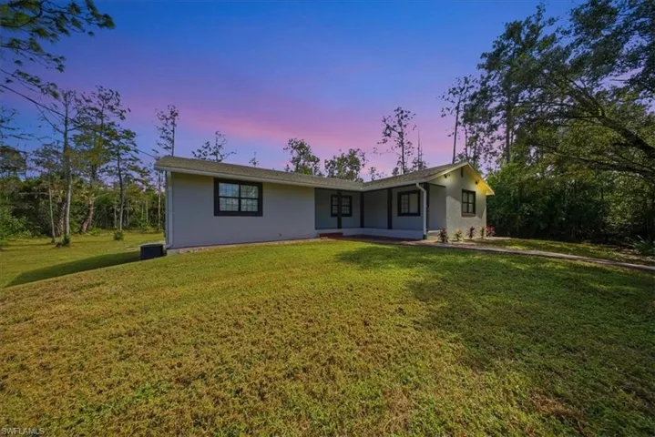 Single story home featuring a front lawn and stucco siding