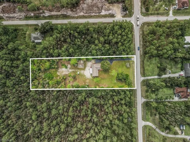 Aerial view of property and surrounding area featuring property parcel outlined