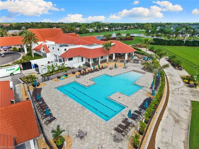 Community pool featuring a patio, a water view, and view of golf course