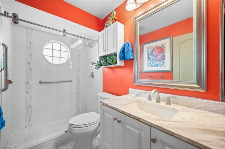 Full bathroom with vanity and a shower stall