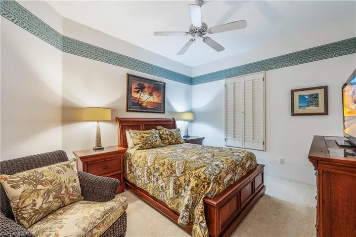Carpeted Guest Bedroom 2, ceiling fan, plantations covered window closet not shown
