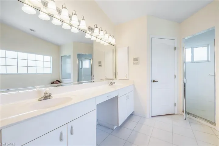 Primary Bathroom, tile floors, and double sink vanity private W/C