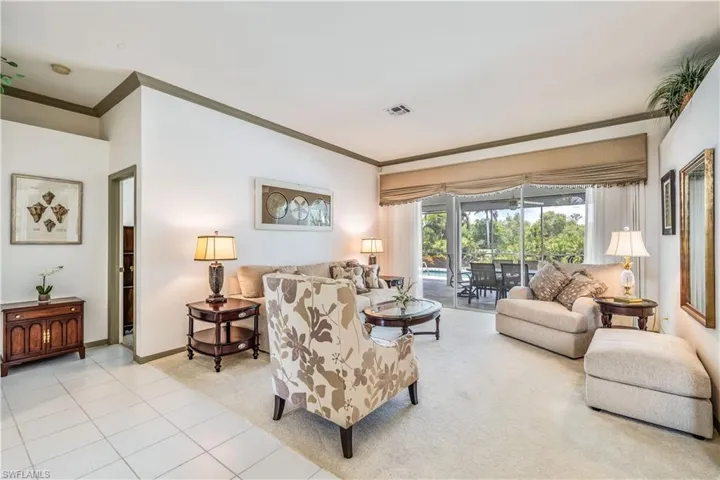 Carpeted living room with crown molding