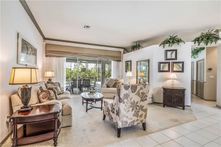 Living room from front doors to sliding patio doors to pool and lanai