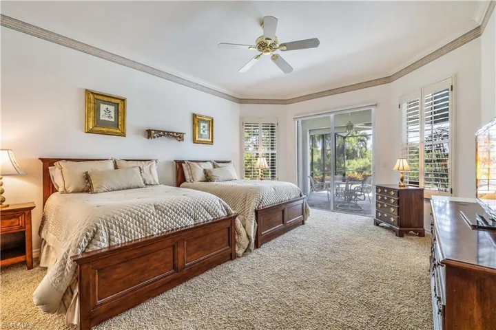 Carpeted Primary bedroom with multiple windows, ceiling fan, access to exterior, and crown molding