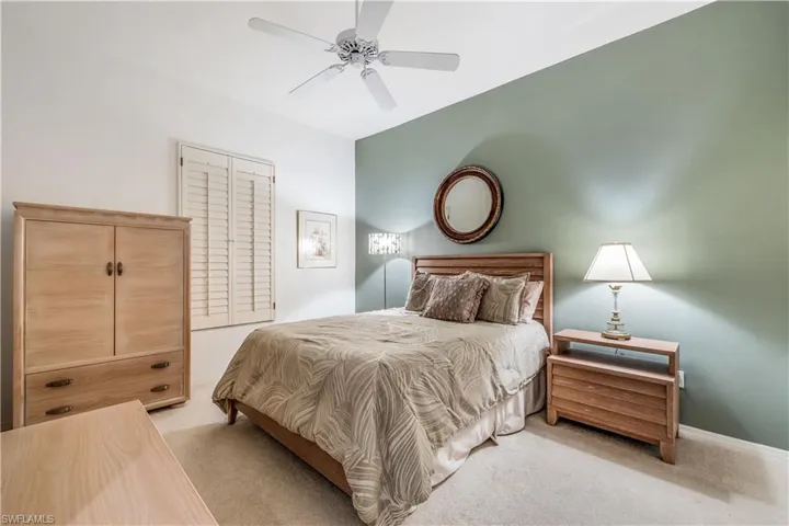Carpeted Guest Bedroom  w/ceiling fan plantation shutters on window large closet not shown