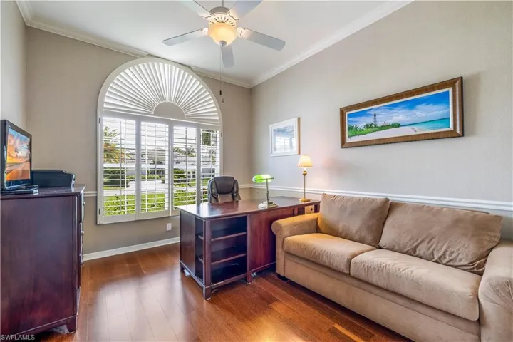Office with, ceiling fan, and wood flooring plantation shutters East exposure
