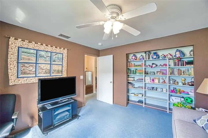 Sitting room featuring carpet floors and ceiling fan