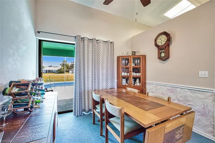 Dining space featuring ceiling fan and wainscoting