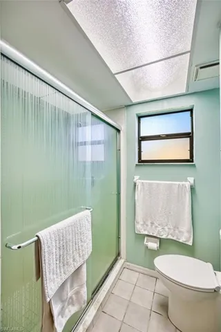 Full bathroom featuring a stall shower and tile patterned flooring