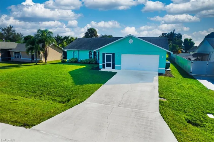 Single story home featuring concrete driveway, stucco siding, and an attached garage