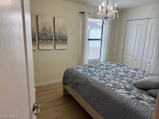 Bedroom #4 with a chandelier, carpet flooring, and a closet