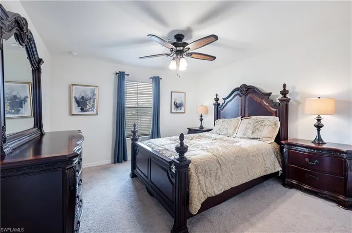 Bedroom #5 Carpeted bedroom with ceiling fan and baseboards