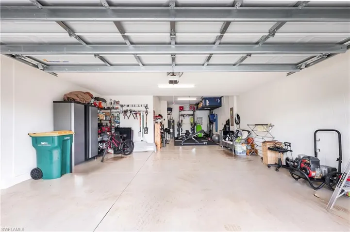 3 car TANDEM Garage featuring a garage door opener