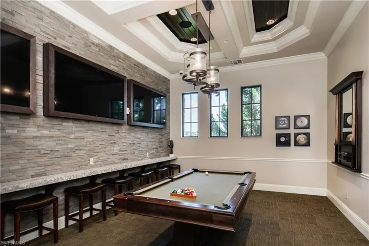 Playroom featuring crown molding, a chandelier, coffered ceiling, beam ceiling, and billiards table