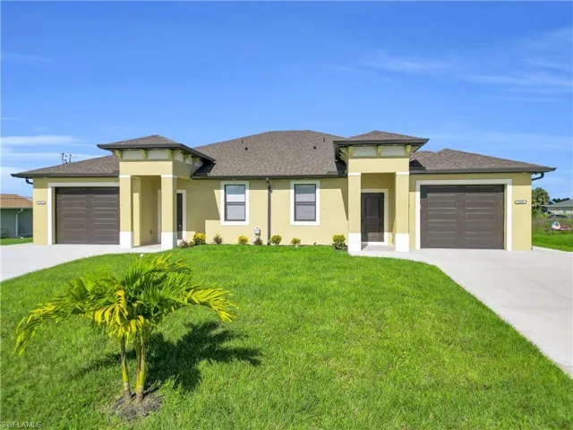 Prairie-style home featuring stucco siding, concrete driveway, and roof with shingles