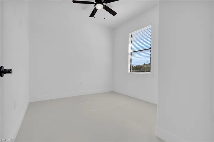 Unfurnished room with baseboards and ceiling fan