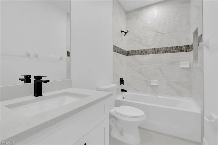 Full bath featuring  shower combination and vanity