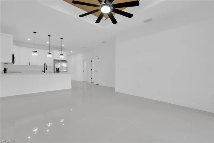 Unfurnished living room featuring light tile patterned floors, recessed lighting, and a ceiling fan