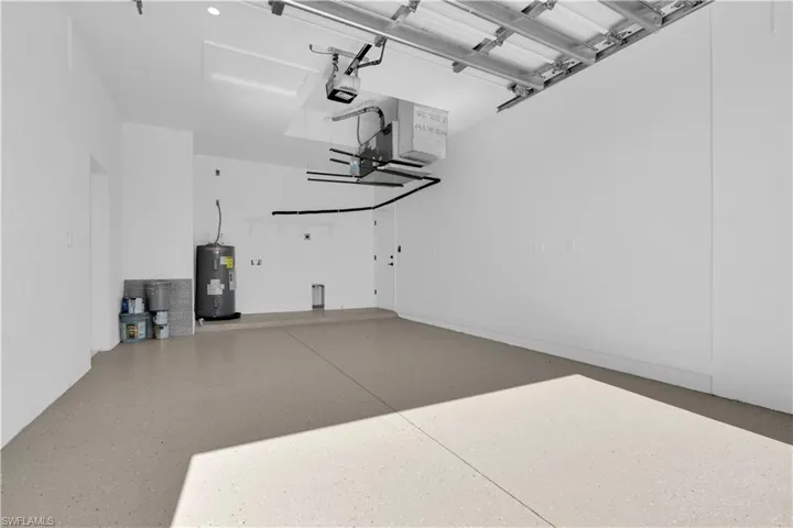 Garage with electric water heater and a garage door opener