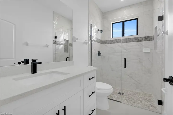 Bathroom featuring vanity and a stall shower