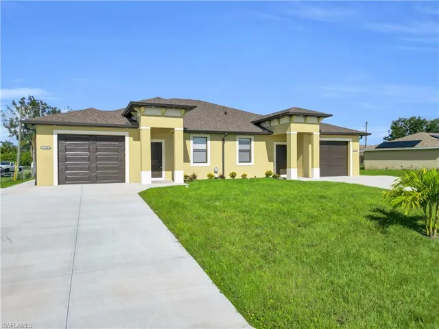 Prairie-style house with a front yard, an attached garage, and stucco siding