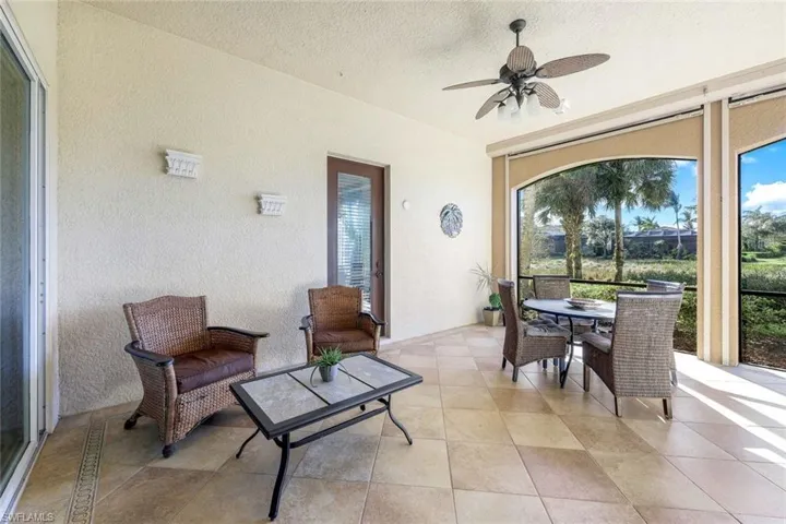 Sunroom / solarium featuring ceiling fan