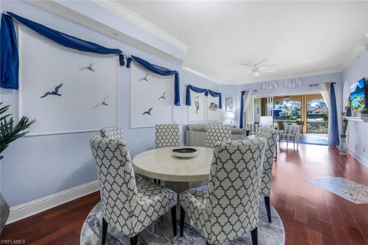 Dining area with ceiling fan, dark hardwood / wood-style floors, and ornamental molding