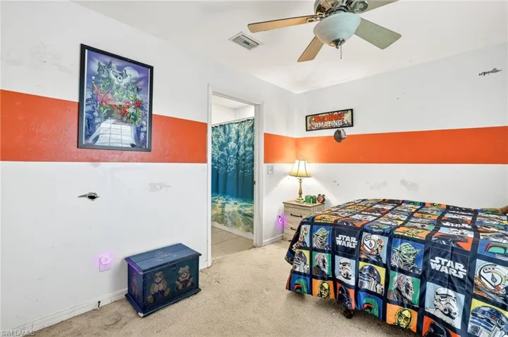 Carpeted bedroom with ensuite bathroom