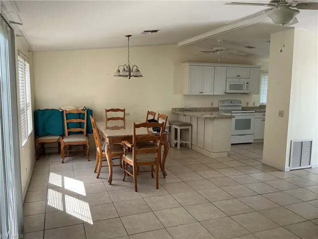 Dining room with a chandelier and light tile patterned floors