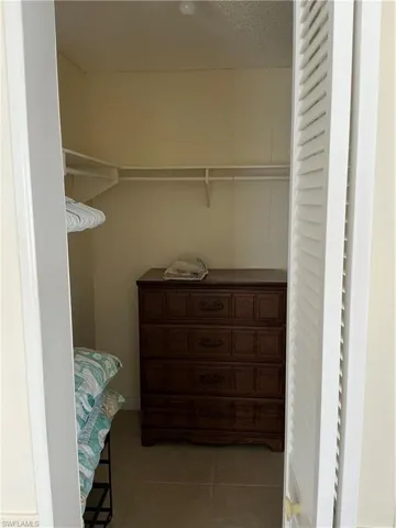 Spacious closet with light tile patterned flooring