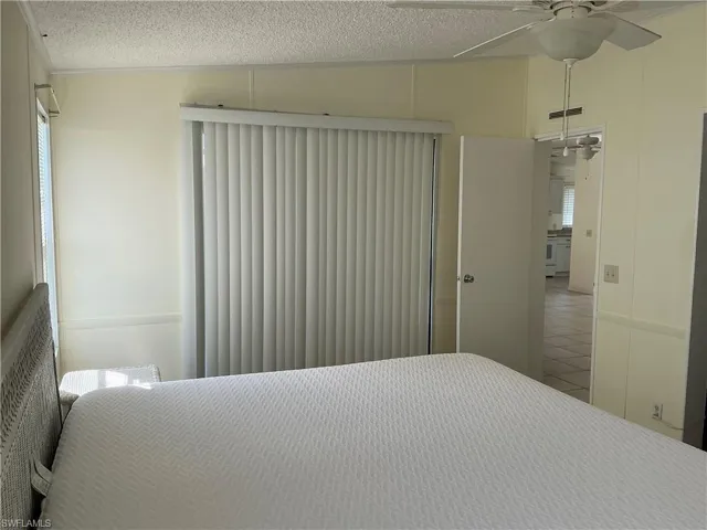 Bedroom featuring a textured ceiling and a ceiling fan