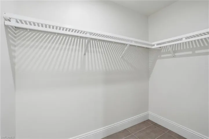 Walk in closet featuring light tile patterned flooring