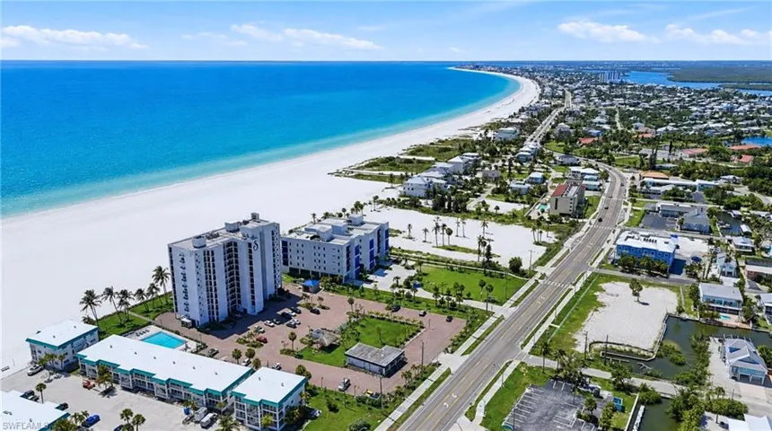 Coastal residential area featuring direct beachfront access and aquatic amenities - Virtually Edited Image