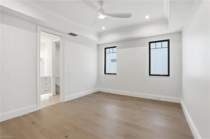Unfurnished bedroom featuring light wood-style flooring, ornamental molding, ceiling fan, and recessed lighting