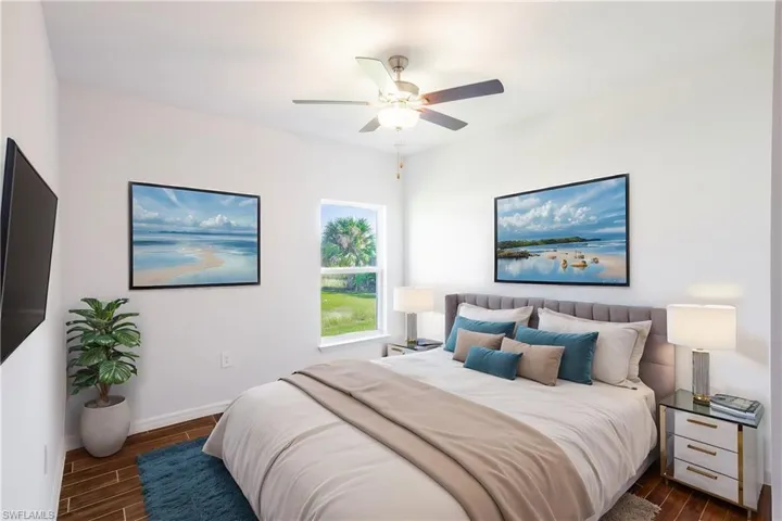 Bedroom with ceiling fan and dark hardwood / wood-style flooring