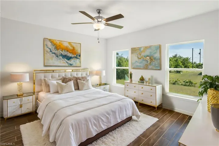 Bedroom with multiple windows and ceiling fan