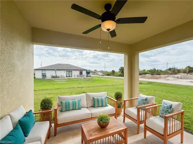 View of patio with ceiling fan and an outdoor living space