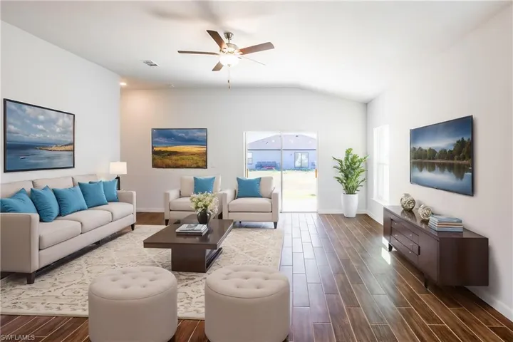 Living room with ceiling fan and vaulted ceiling