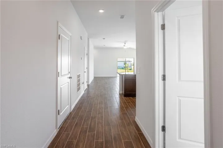 Hall with dark hardwood / wood-style flooring