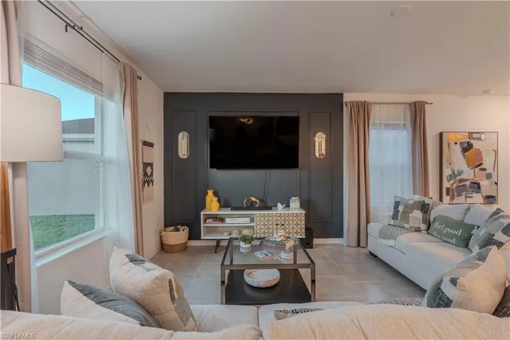 Living room with plenty of natural light and tile patterned floors