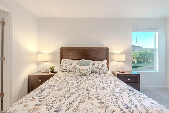 Bedroom featuring carpet flooring and baseboards