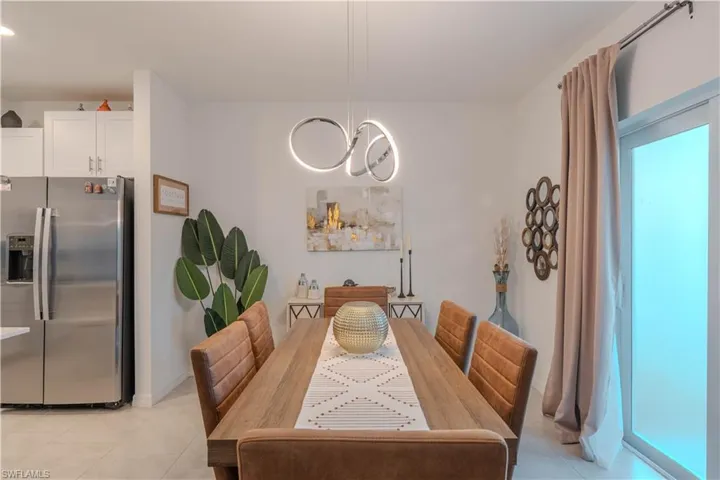 Dining area with light tile patterned floors