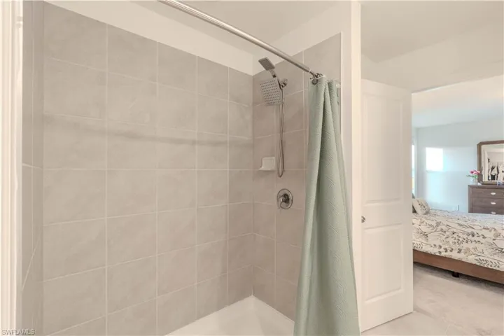 Ensuite bathroom featuring a shower stall