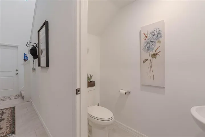 Bathroom featuring baseboards and light tile patterned floors