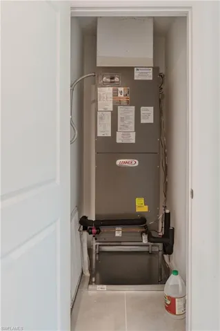 Utility room featuring heating unit