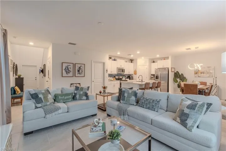 Living room featuring recessed lighting, light tile patterned floors, and a chandelier